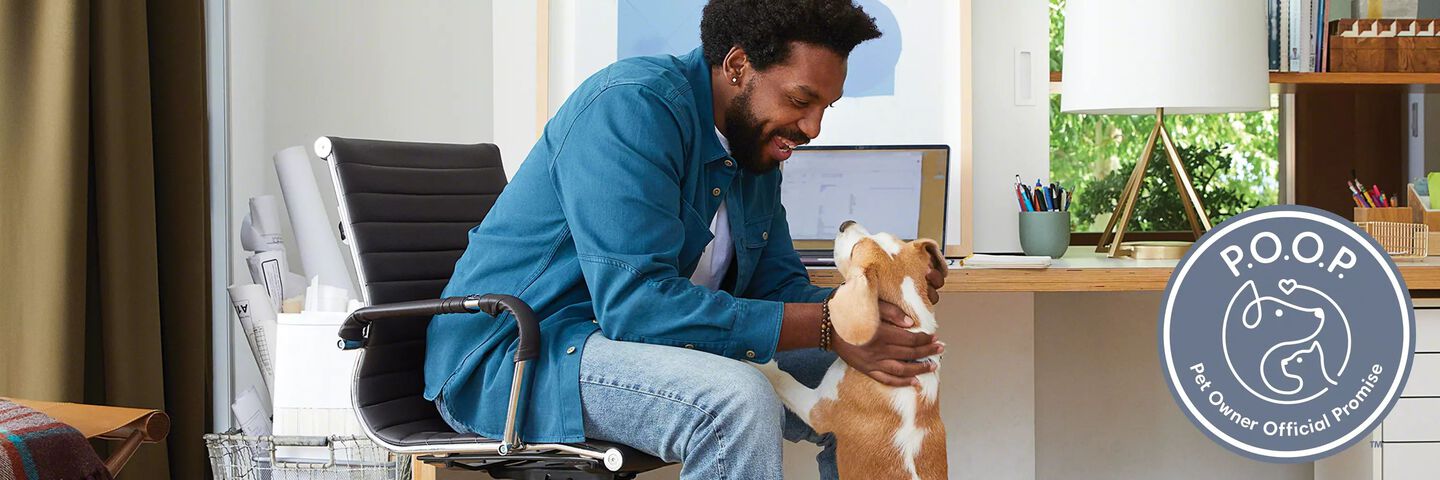 Man with a dog at the computer. Pet Owner Official Promise logo