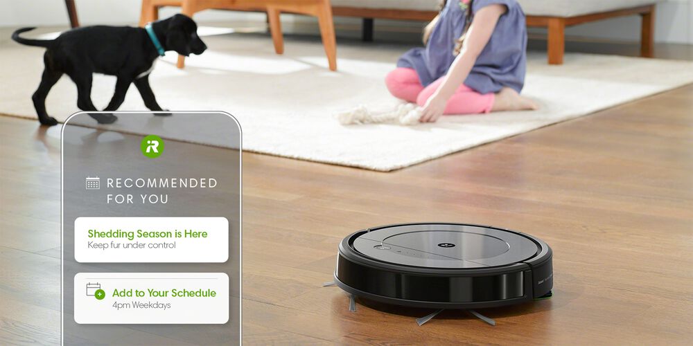 A Roomba with a girl and shedding dog